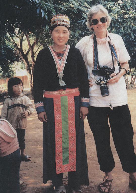 woman holding camera standing next to another woman and a child