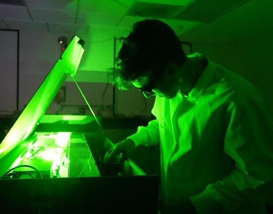 student working with a laser